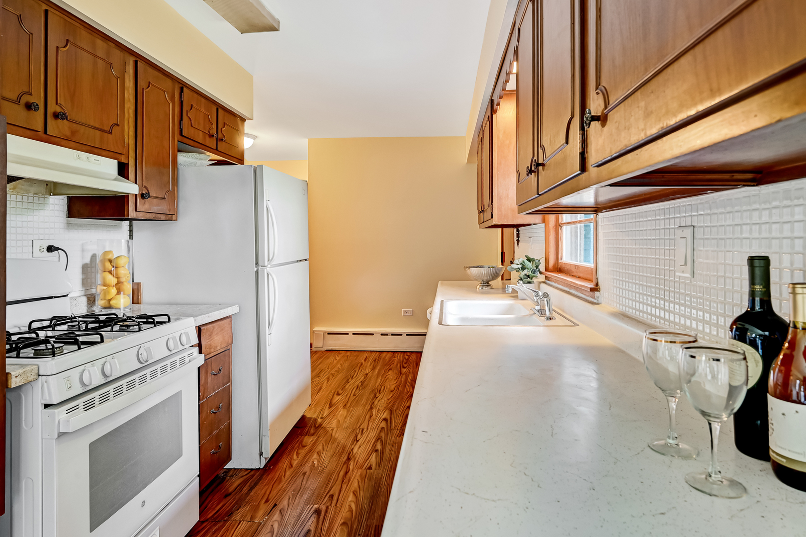 219 79th Street Burr Ridge, IL 60527 - Photo 8 of 28 a kitchen with a sink a stove and a refrigerator