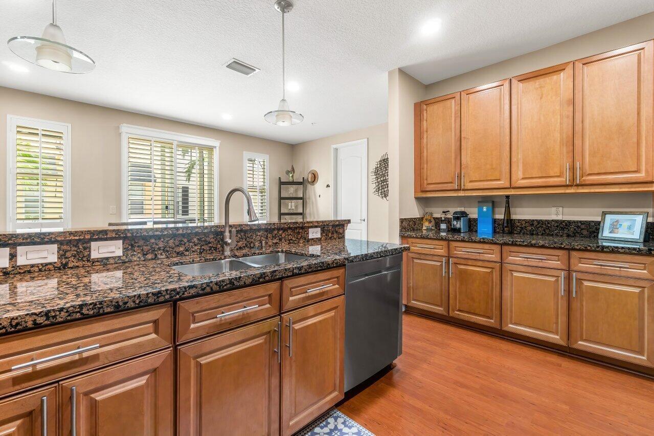 3805 Northwest 5th Terrace Boca Raton, FL 33431 - Photo 11 of 30 a kitchen with granite countertop a sink appliances cabinets and a large window