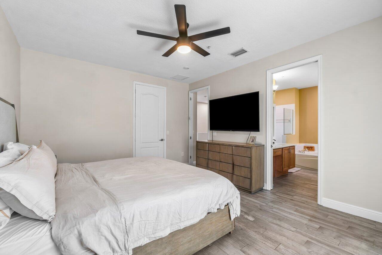 3805 Northwest 5th Terrace Boca Raton, FL 33431 - Photo 22 of 30 a bedroom with a flat screen tv and a bed