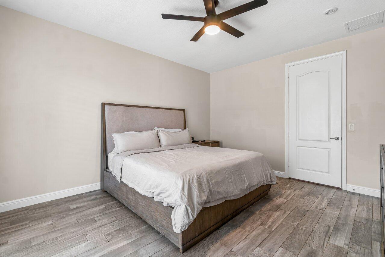 3805 Northwest 5th Terrace Boca Raton, FL 33431 - Photo 23 of 30 a large bed sitting in a bedroom next to a window