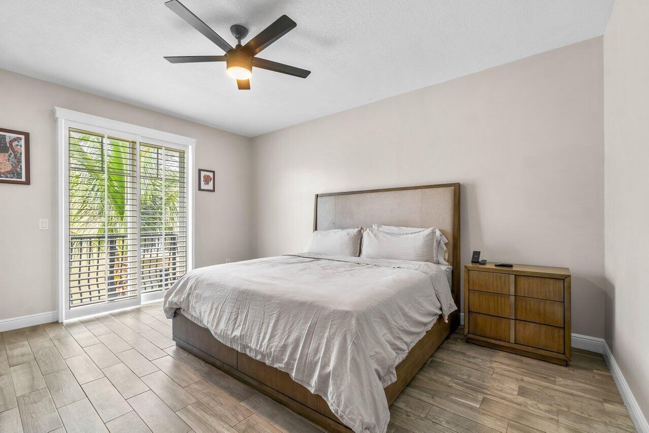 3805 Northwest 5th Terrace Boca Raton, FL 33431 - Photo 25 of 30 a bedroom with a bed and a large window