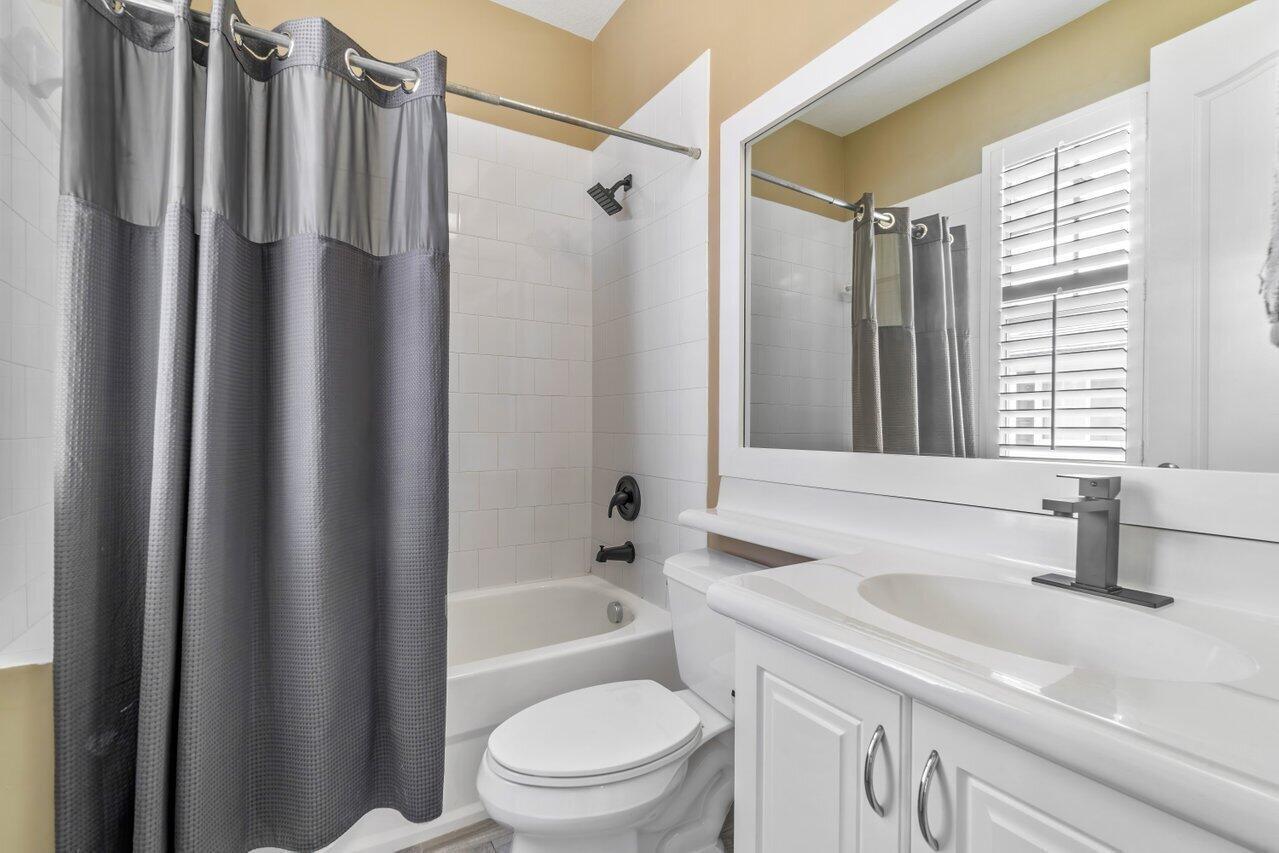 3805 Northwest 5th Terrace Boca Raton, FL 33431 - Photo 29 of 30 a bathroom with a sink a toilet a window and shower