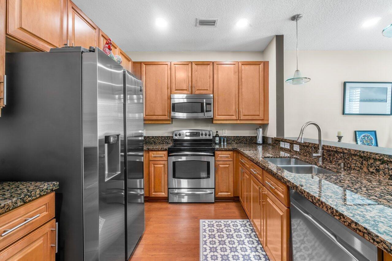 3805 Northwest 5th Terrace Boca Raton, FL 33431 - Photo 9 of 30 a kitchen with stainless steel appliances granite countertop a refrigerator and a sink