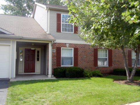 1020 Chaucer Court, Unit A Elgin, IL 60120 - Photo 2 of 10 a front view of a house with a yard