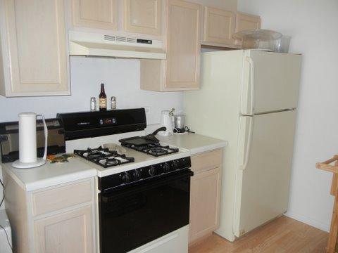 1020 Chaucer Court, Unit A Elgin, IL 60120 - Photo 5 of 10 a kitchen with stainless steel appliances a stove a refrigerator and a cabinets