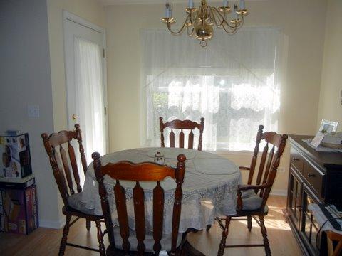 1020 Chaucer Court, Unit A Elgin, IL 60120 - Photo 8 of 10 a view of a dining room with furniture window and outside view