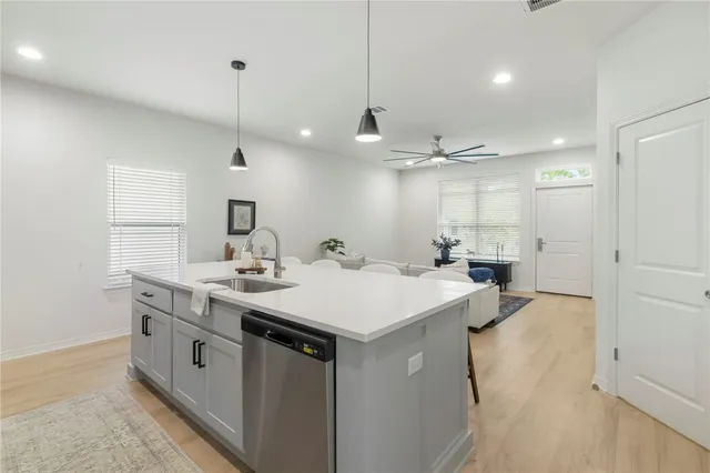a kitchen with stainless steel appliances a stove a microwave and cabinets