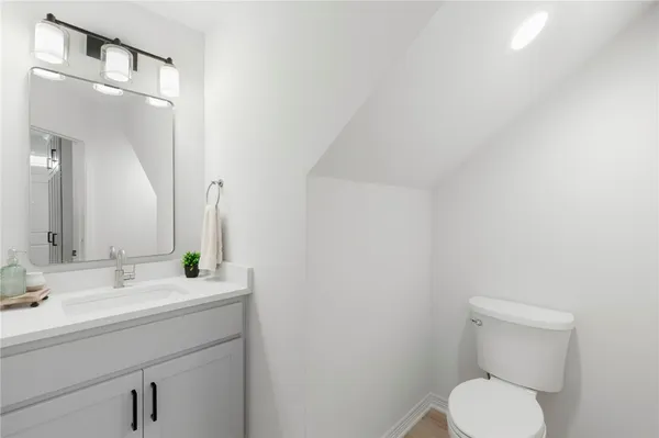 a kitchen with white cabinets sink and stainless steel appliances