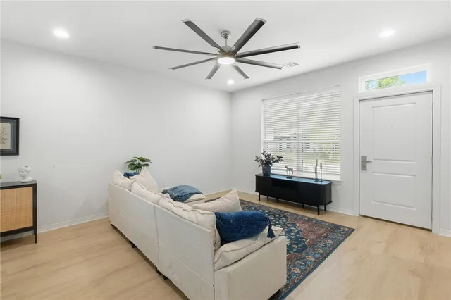 a living room with furniture and a potted plant