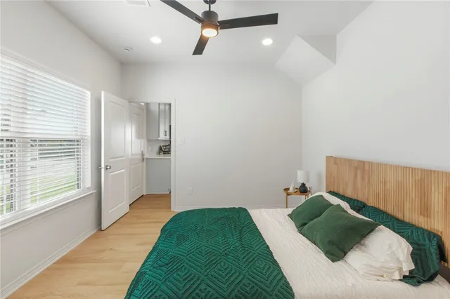 a bedroom with a bed and hallway