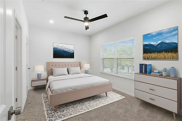 an empty room with windows and ceiling fan