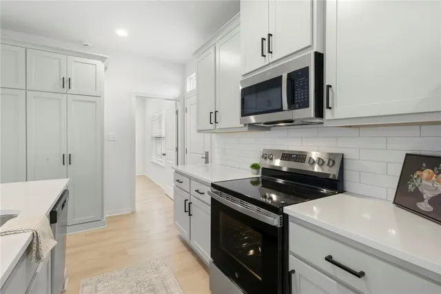 a view of a kitchen counter space a sink and dishwasher