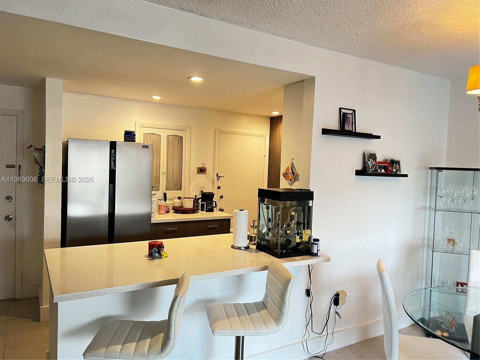 9159 Southwest 77th Avenue, Unit 311 Miami, FL 33156 - Photo 2 of 17 a large kitchen with a table and chairs