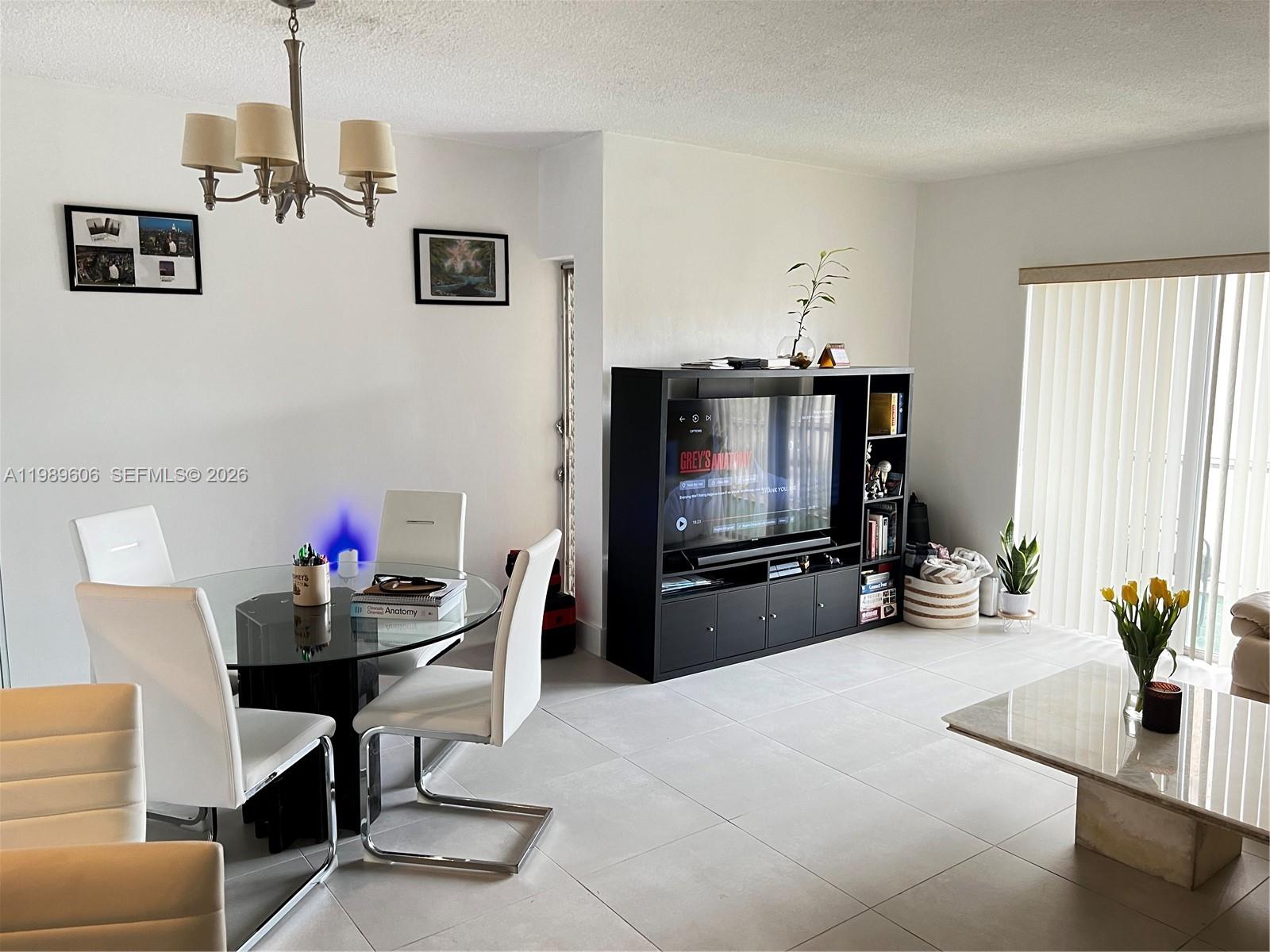 9159 Southwest 77th Avenue, Unit 311 Miami, FL 33156 - Photo 4 of 17 a living room with furniture and a flat screen tv