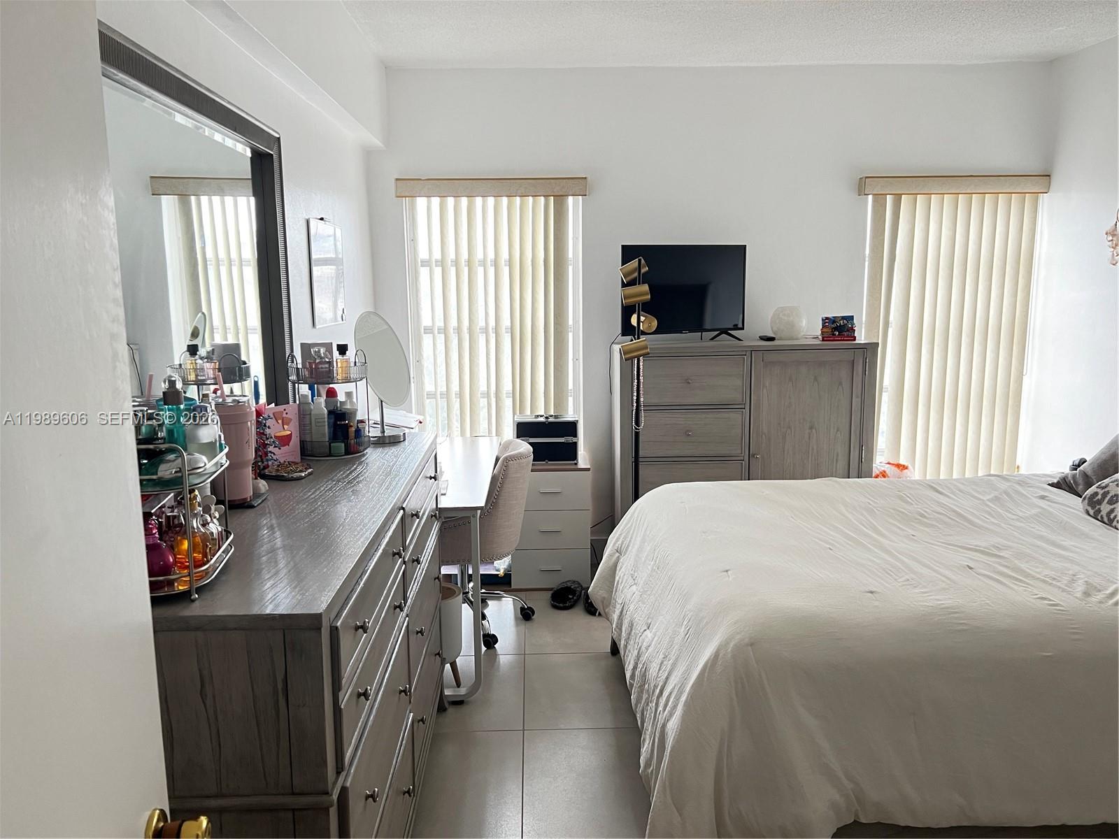 9159 Southwest 77th Avenue, Unit 311 Miami, FL 33156 - Photo 8 of 17 a bedroom with a bed and furniture