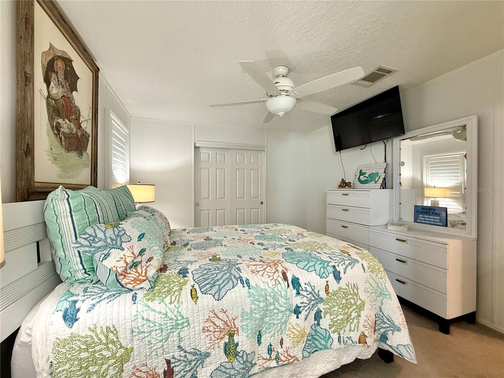 124 East St Annes Circle Apollo Beach, FL 33572 - Photo 11 of 26 a bedroom with a bed and a chandelier