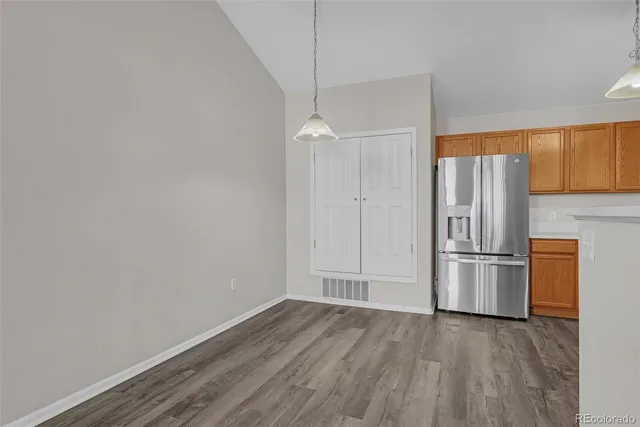 a view of a kitchen with a sink and a refrigerator