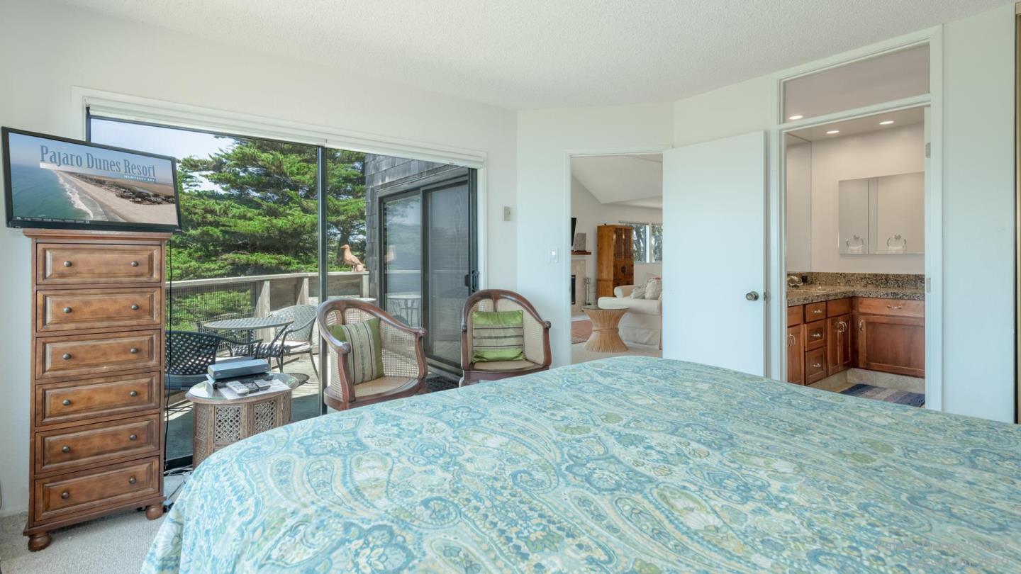 101 Shell Road, Unit 102 Watsonville, CA 95076 - Photo 14 of 20 a bedroom with a bed and a large mirror