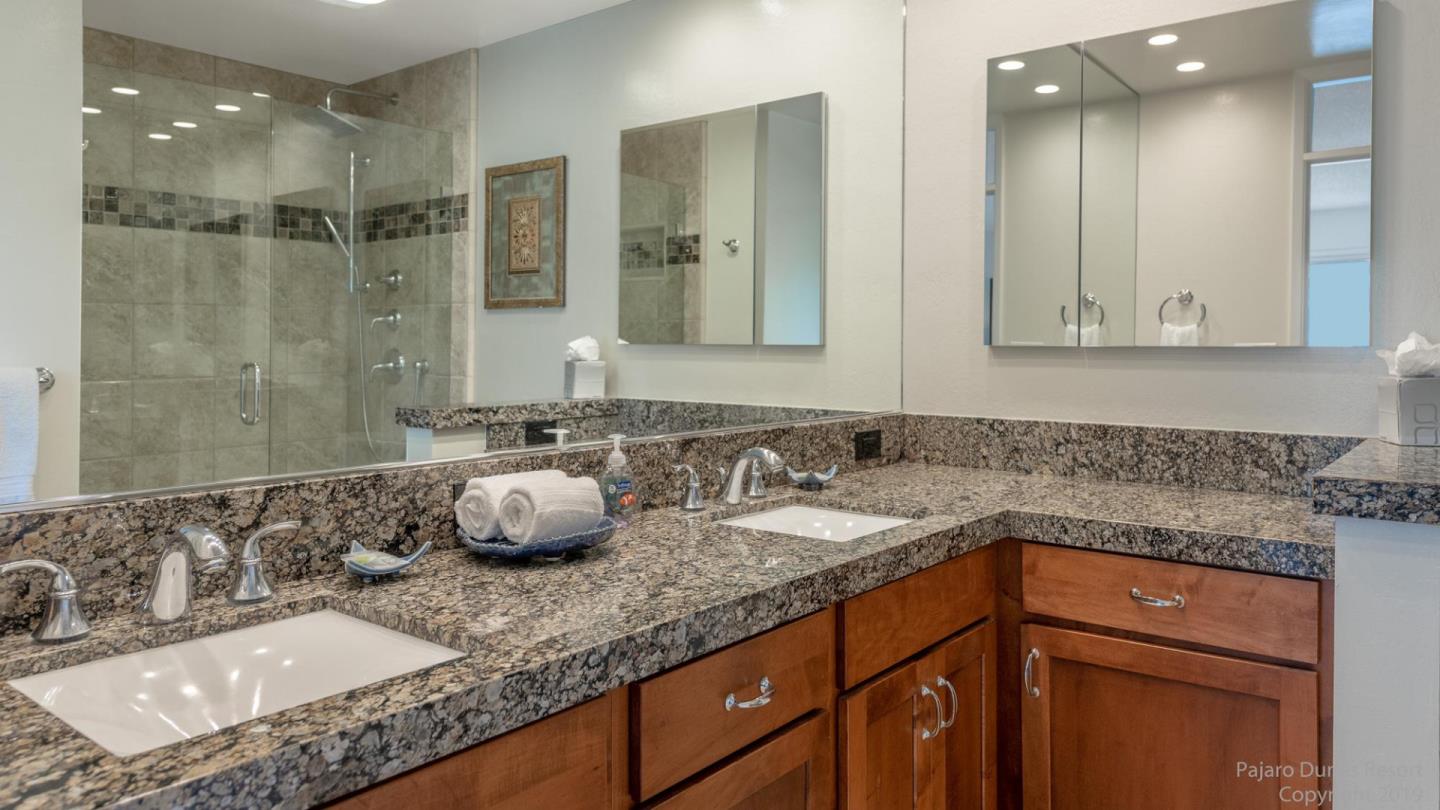 101 Shell Road, Unit 102 Watsonville, CA 95076 - Photo 15 of 20 a bathroom with a granite countertop sink a mirror and shower