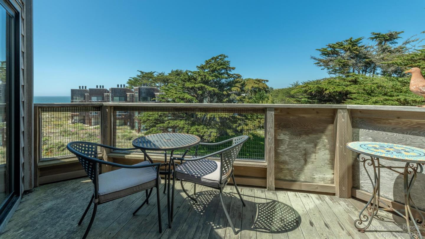 101 Shell Road, Unit 102 Watsonville, CA 95076 - Photo 16 of 20 a balcony with furniture and wooden floor