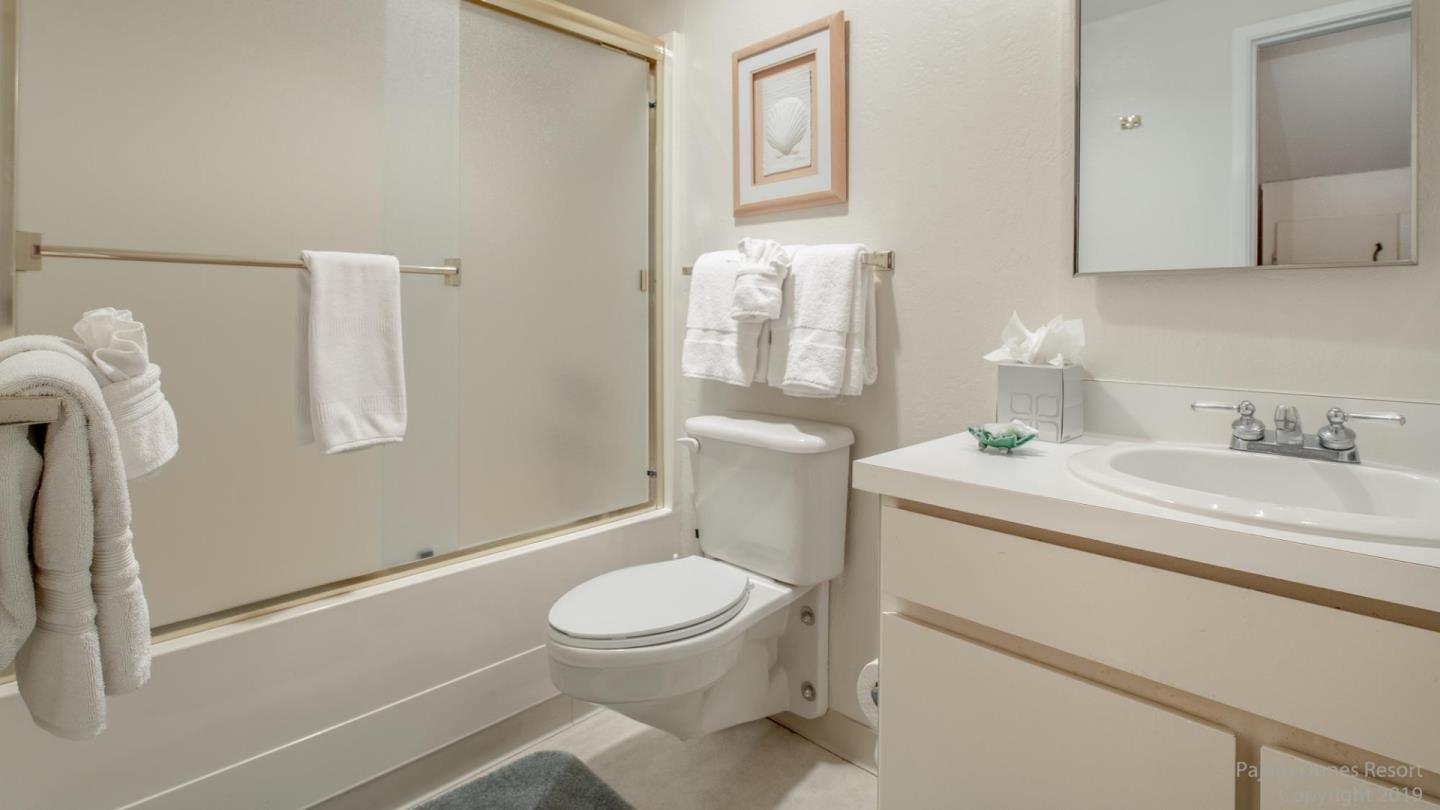 101 Shell Road, Unit 102 Watsonville, CA 95076 - Photo 18 of 20 a bathroom with a granite countertop toilet sink and mirror