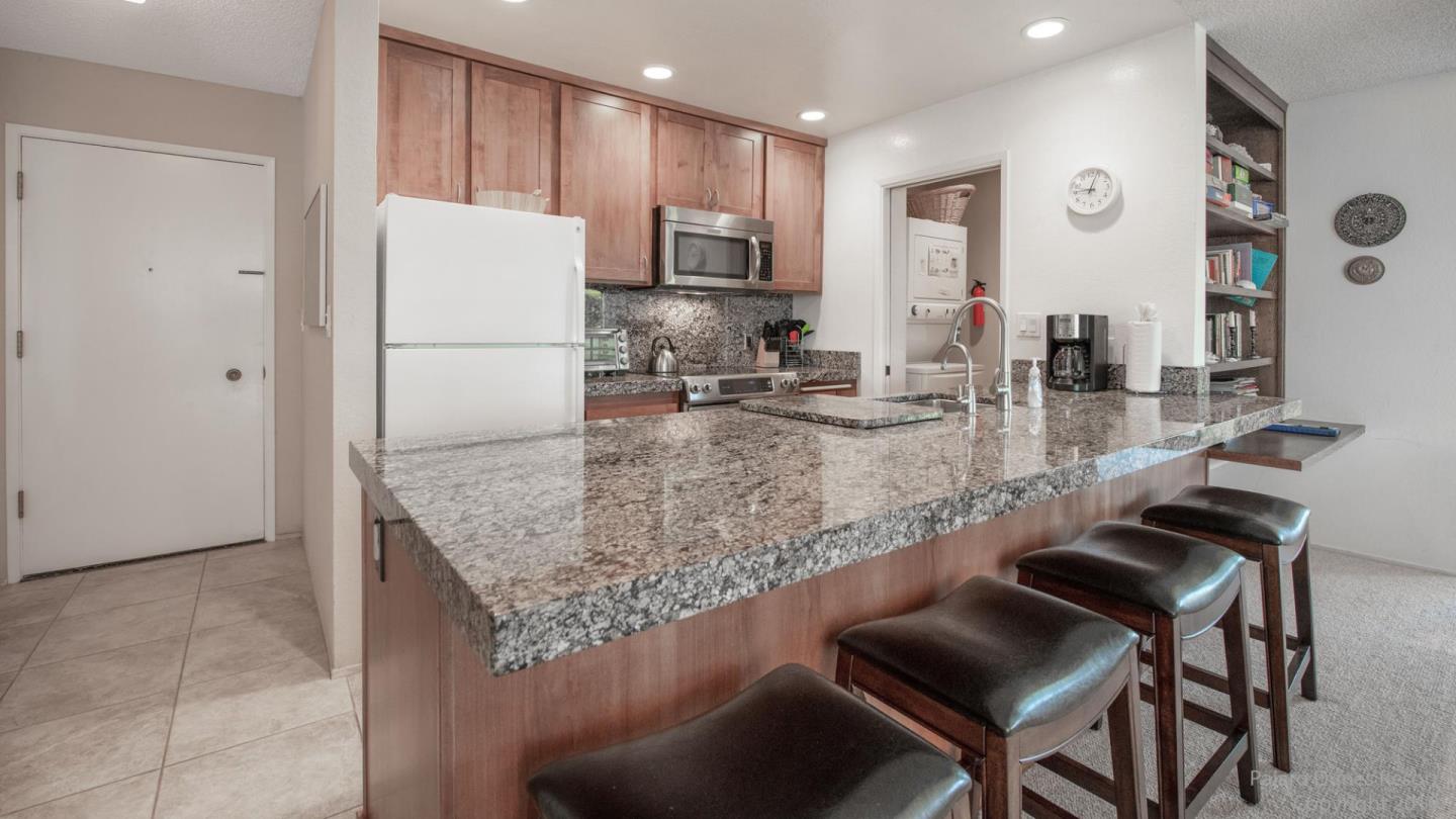 101 Shell Road, Unit 102 Watsonville, CA 95076 - Photo 8 of 20 a kitchen with kitchen island a counter top space appliances and a refrigerator
