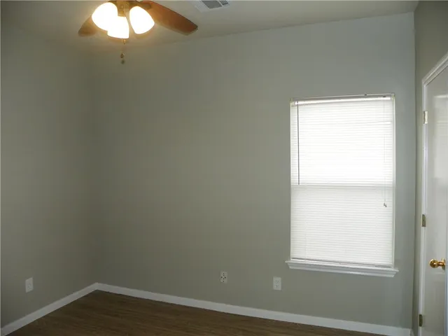 a view of a small space with wooden floor and windows