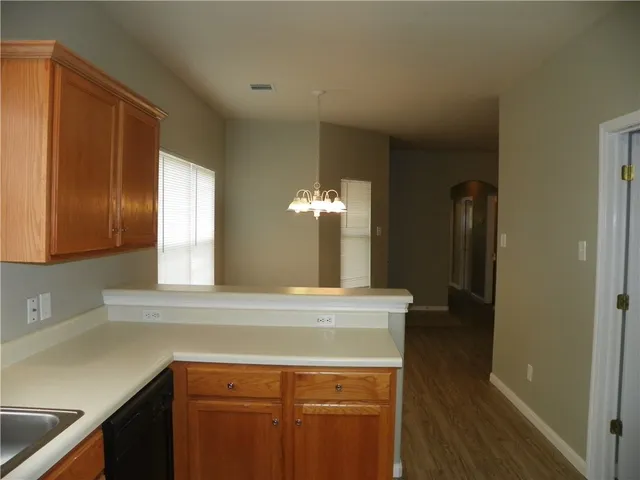 a kitchen with a sink and a mirror