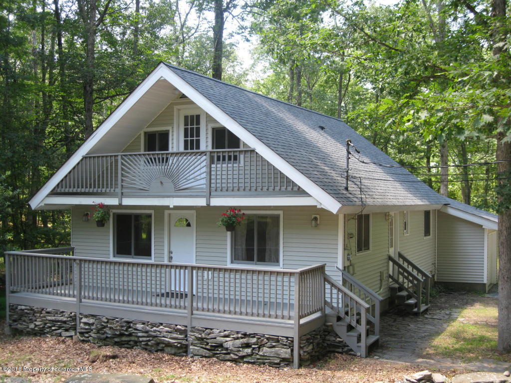 113 Weasel Road Dingmans Ferry, PA 18328 - Photo 1 of 6 a view of small white house with large windows next to a yard