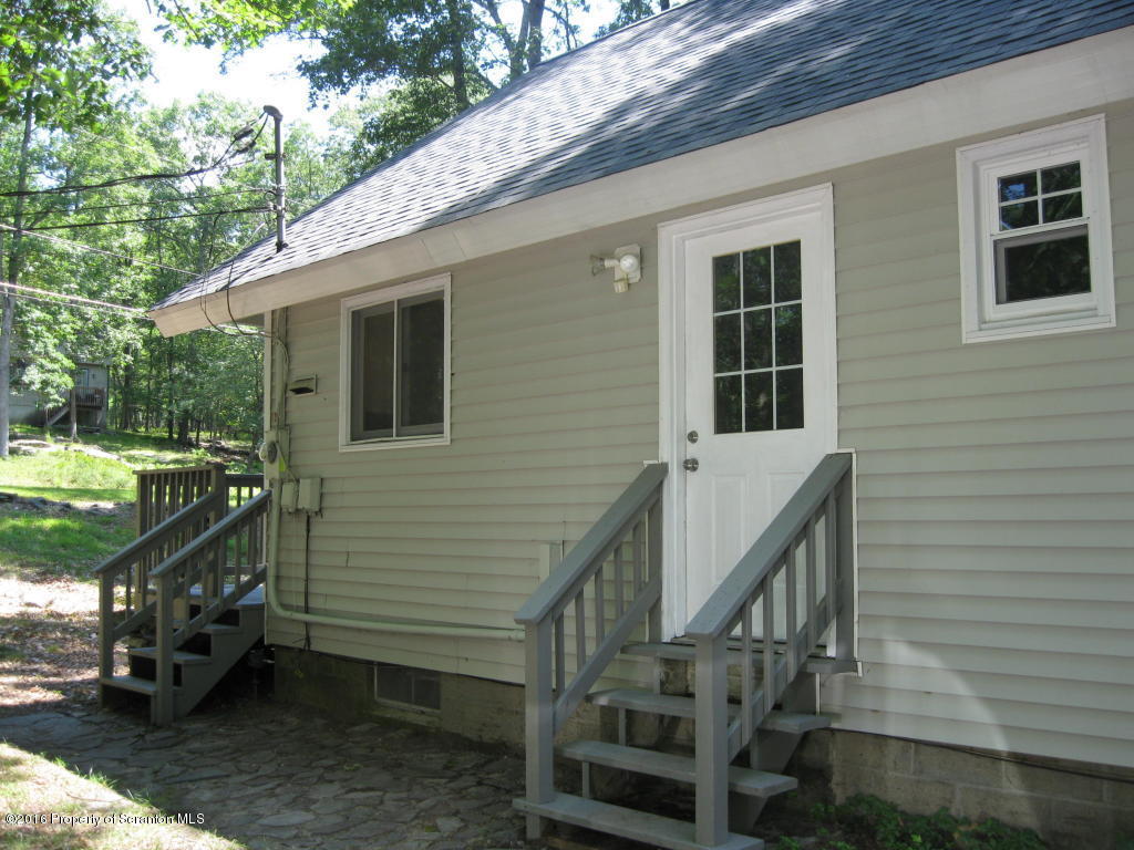113 Weasel Road Dingmans Ferry, PA 18328 - Photo 3 of 6 a view of a house with backyard and deck