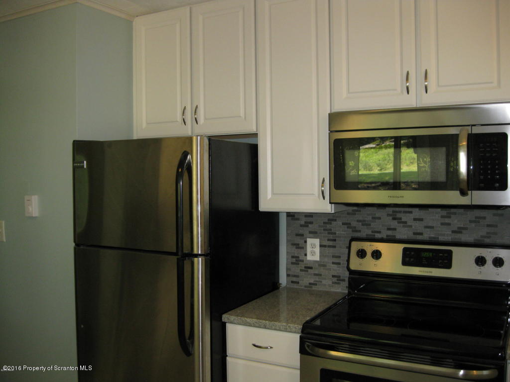 113 Weasel Road Dingmans Ferry, PA 18328 - Photo 6 of 6 a kitchen with appliances and cabinets