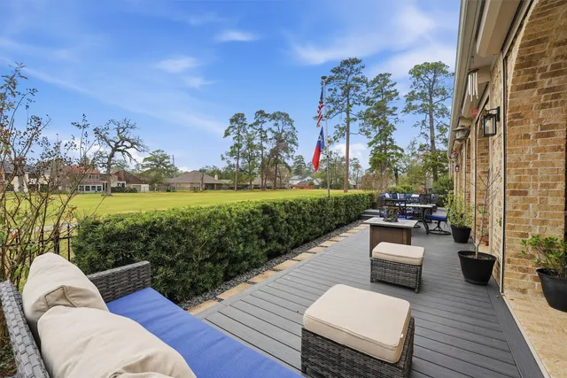 a view of a roof deck with couches and potted plants