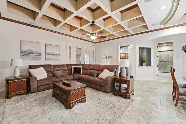 a living room with furniture and a chandelier