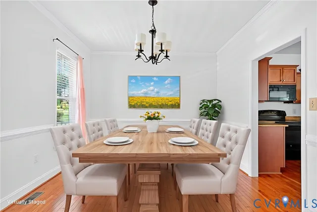 a view of a dining room with furniture window and wooden floor