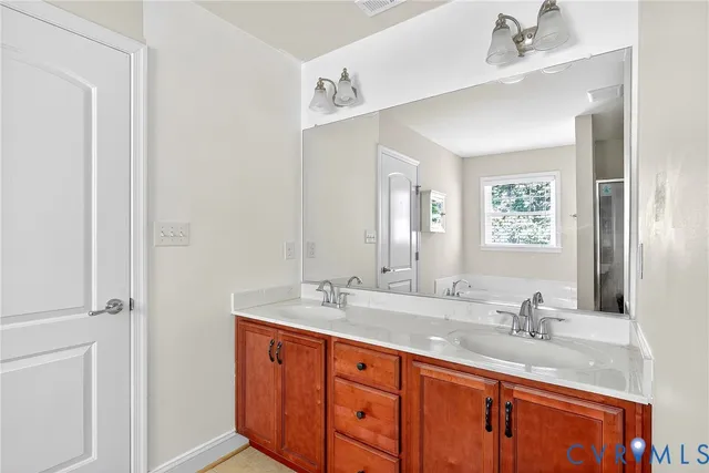 a bathroom with double sink and a mirror