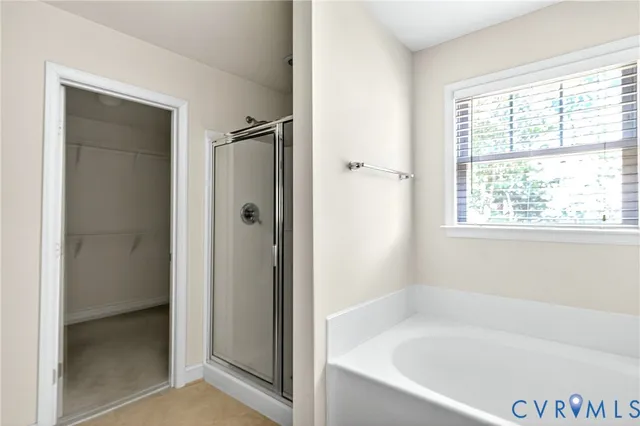 a white bath tub sitting next to a shower