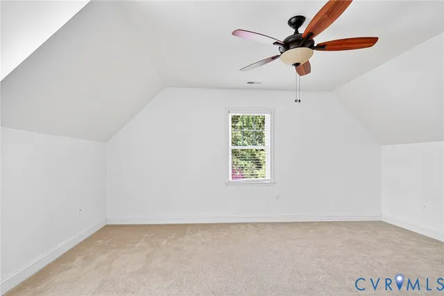 an empty room with a window and a ceiling fan