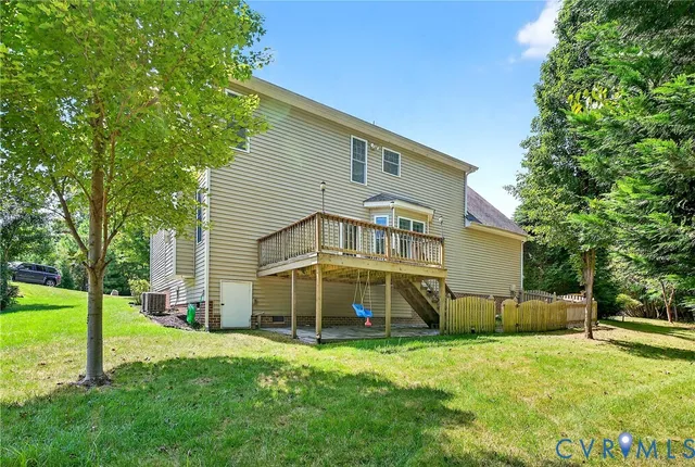 a view of a house with a yard and sitting area