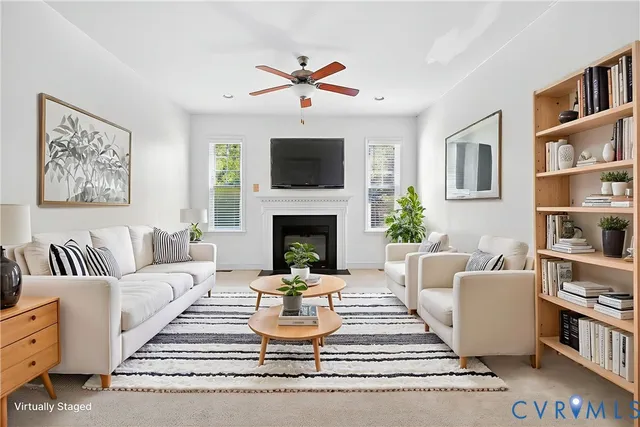 a living room with furniture fireplace and flat screen tv
