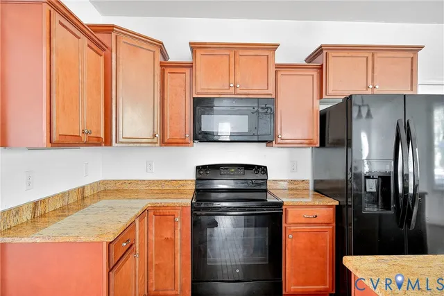 a kitchen with stainless steel appliances granite countertop a refrigerator stove and microwave