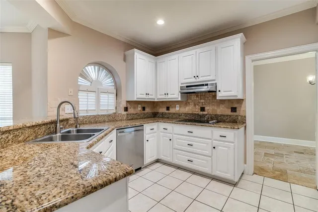 a kitchen with white cabinets and a stove