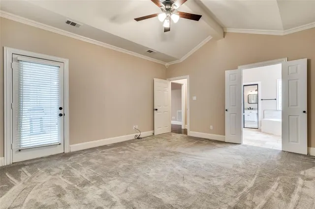 an empty room with a ceiling fan and a window
