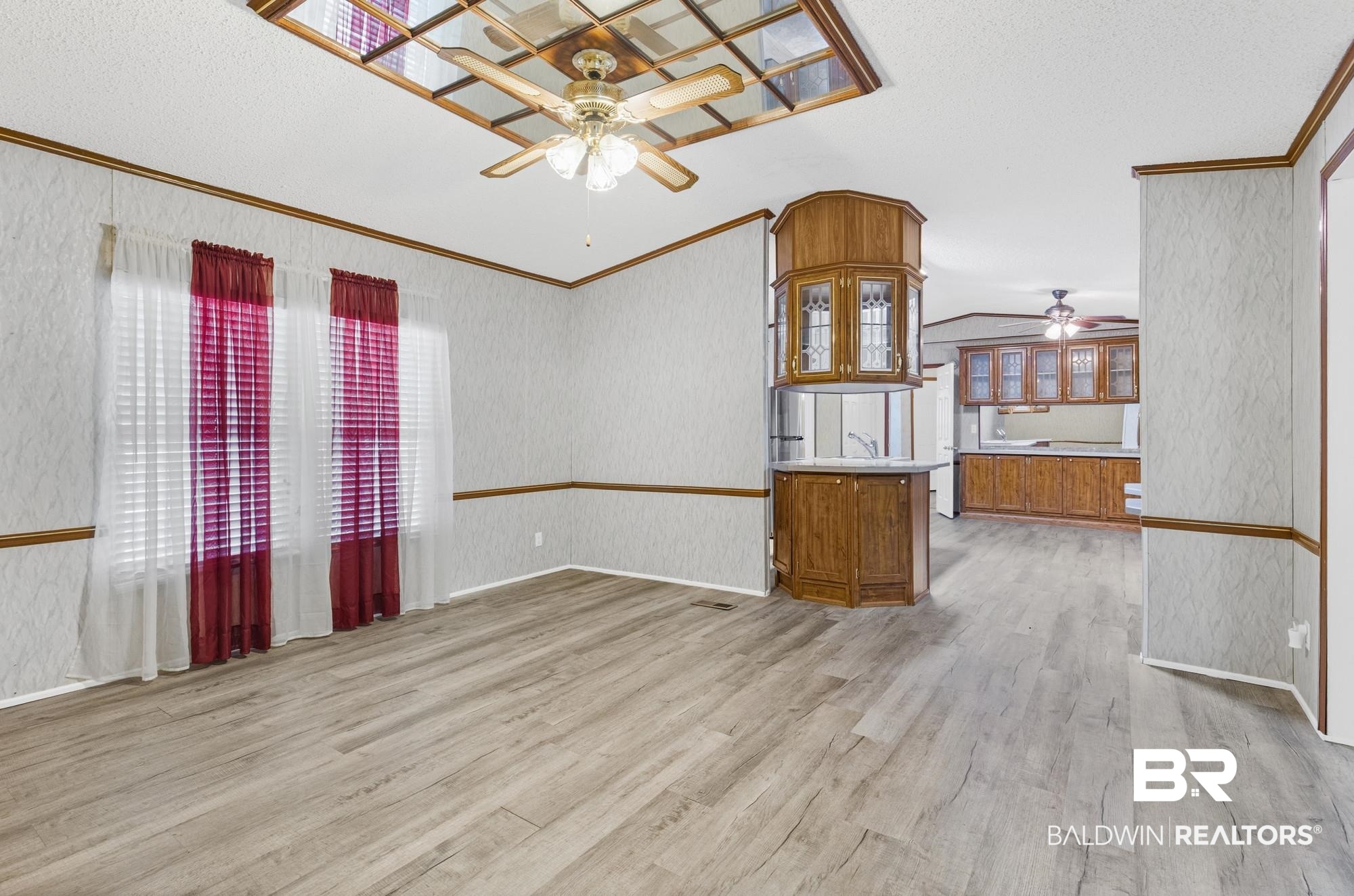 8675 Hunters Pointe Drive North Theodore, AL 36582 - Photo 6 of 20 Spacious open-concept interior featuring light wood-finish flooring and a decorative ceiling fan