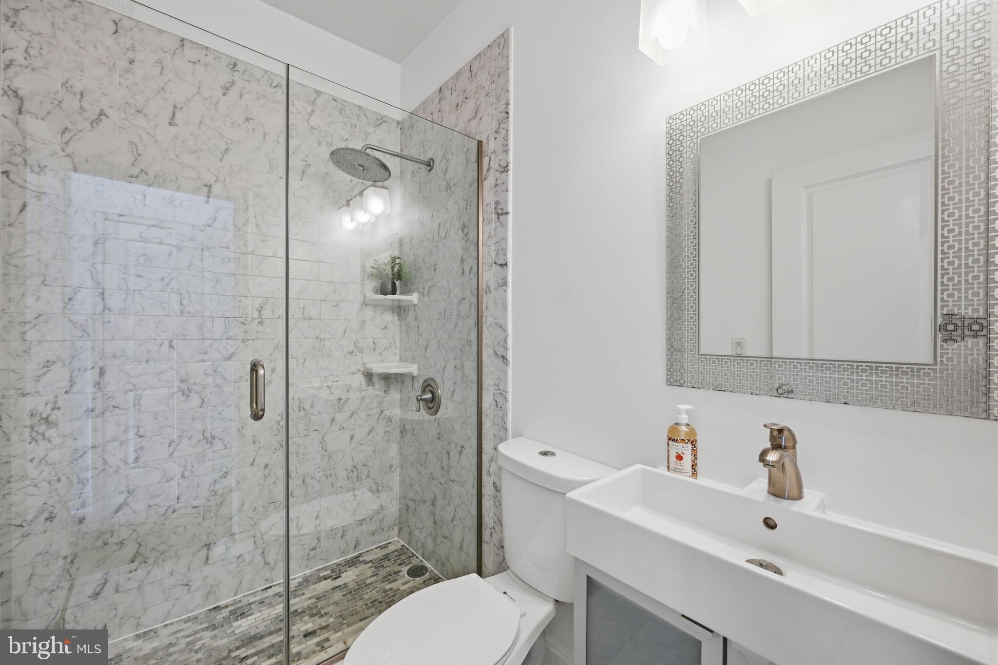524 7th Street Northeast Washington, DC 20002 - Photo 11 of 25 a bathroom with a sink toilet and shower