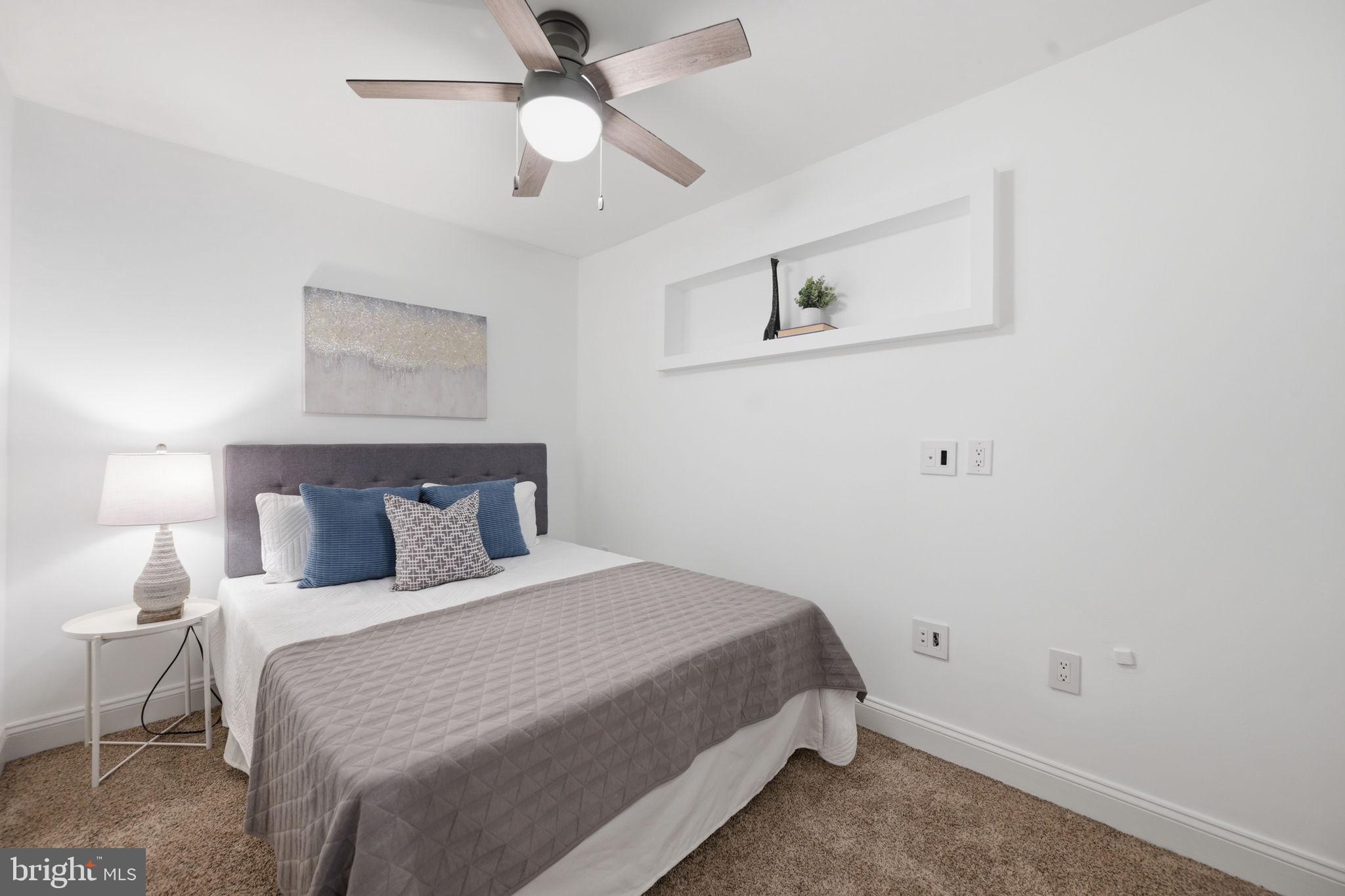 524 7th Street Northeast Washington, DC 20002 - Photo 17 of 25 a bedroom with a bed and a ceiling fan