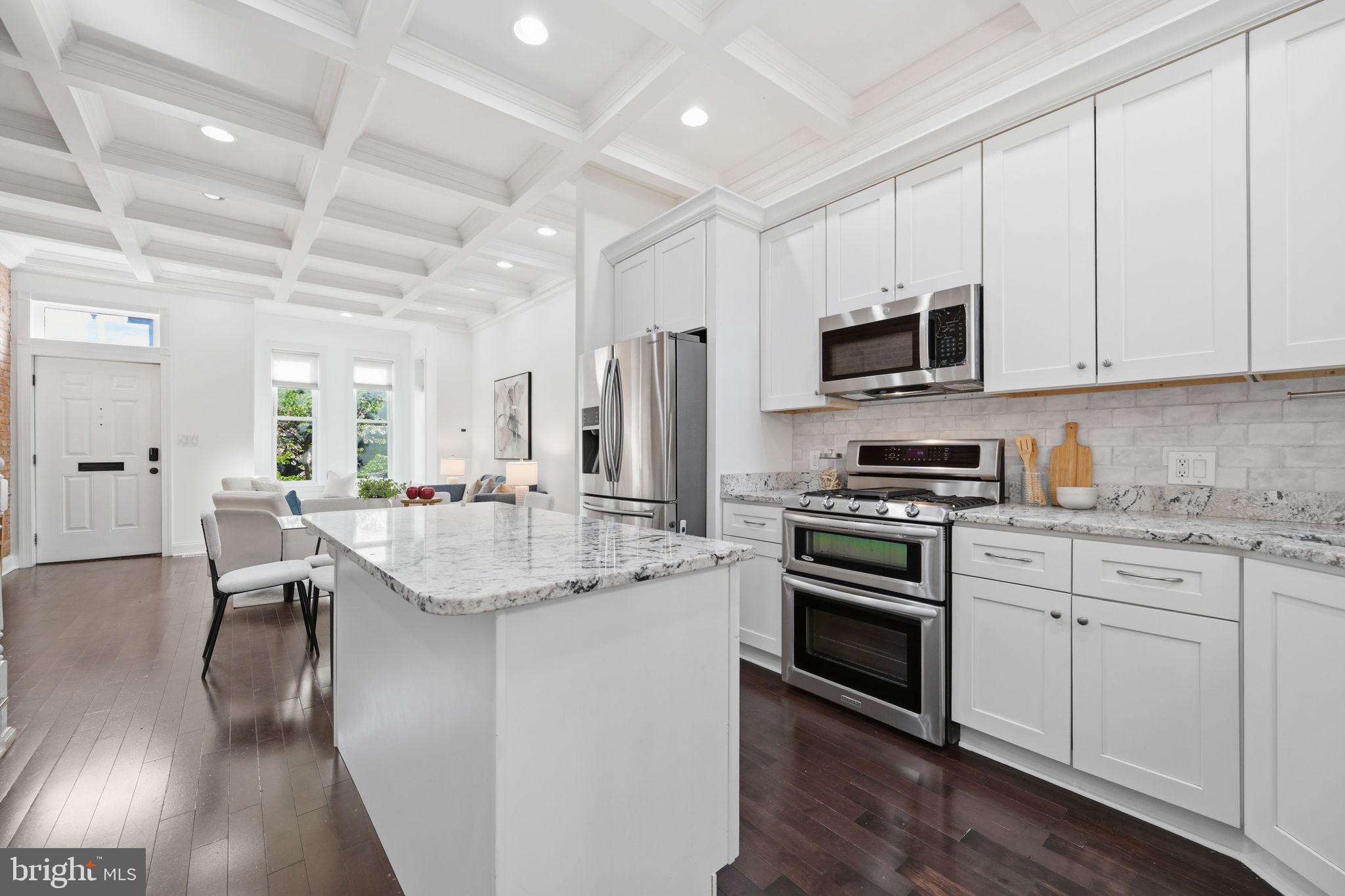 524 7th Street Northeast Washington, DC 20002 - Photo 5 of 25 a kitchen with stainless steel appliances granite countertop a stove top oven a sink and a refrigerator