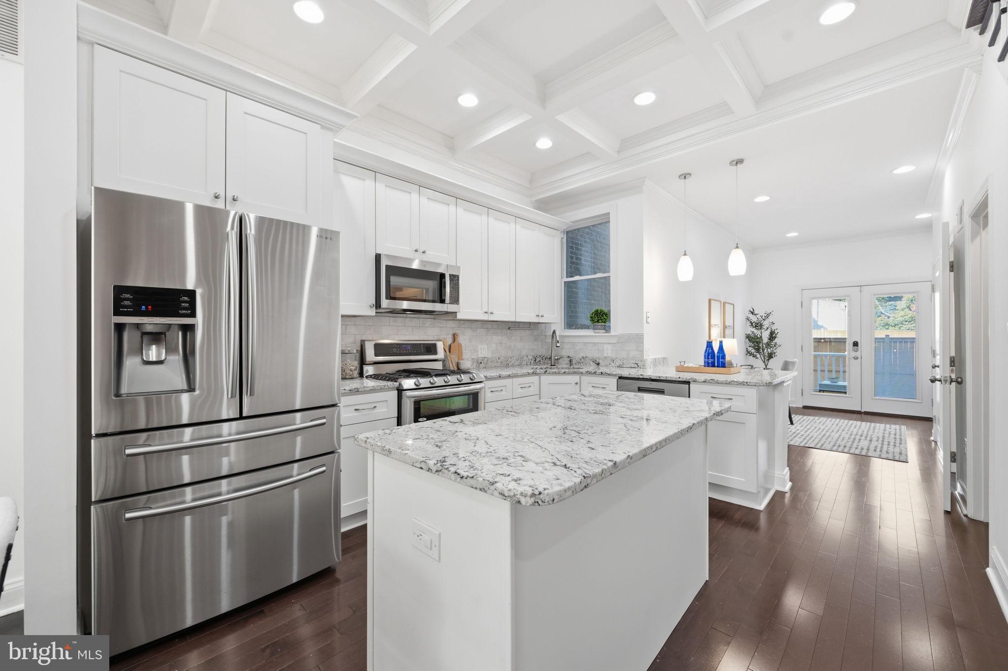 524 7th Street Northeast Washington, DC 20002 - Photo 6 of 25 a kitchen with stainless steel appliances granite countertop a refrigerator stove microwave and cabinets