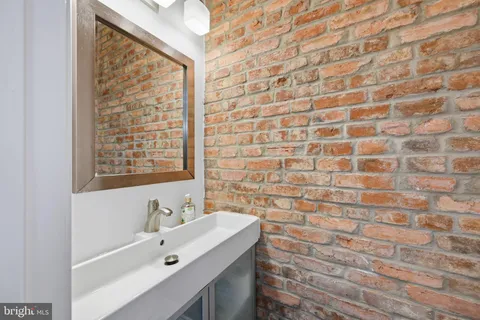 a bathroom with a sink a vanity and a shower