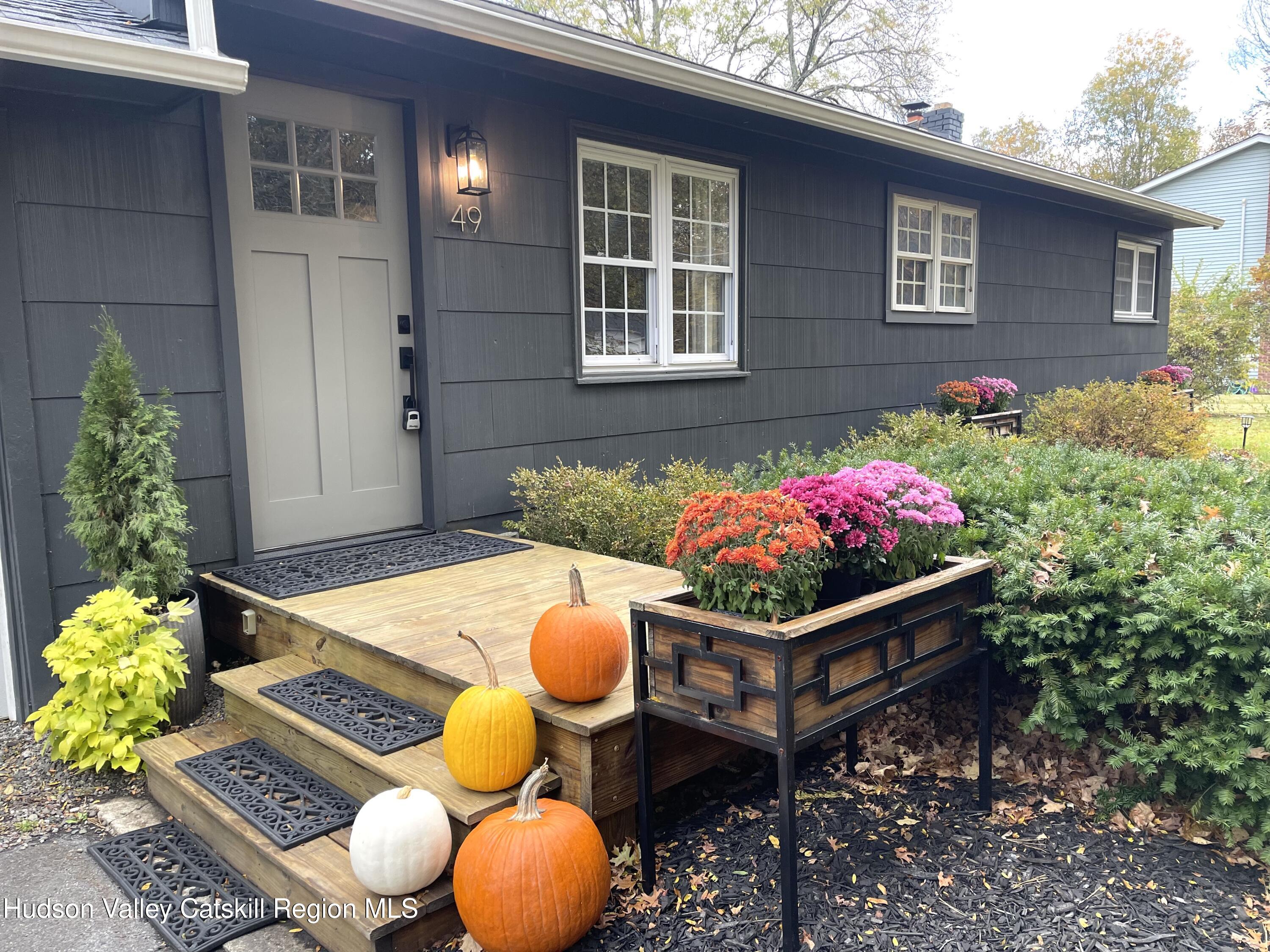 a view of an outdoor sitting area with brick wall and next to a window