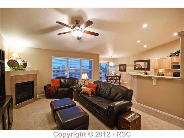 8739 Del Rio Road Peyton, CO 80831 - Photo 6 of 25 A gas-log fireplace w/tile surround warms the spacious vaulted Great Room.